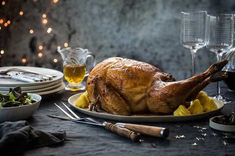 Hele kalkoen met aardappel toefjes op een mooi bekleede tafel